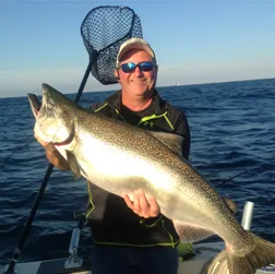 Capt. Bob Poteshman holding a Lake Michigan salmon